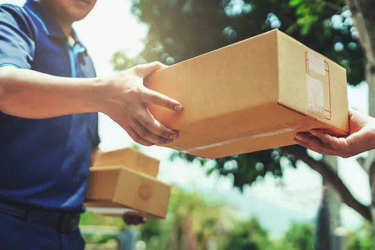 Delivery man carrying boxes